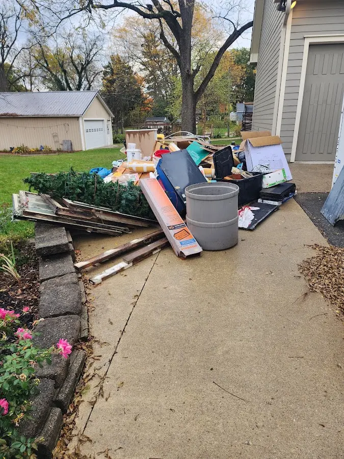 Dumpster being loaded with debris for Estate Cleanout Dumpster Rental in Glenvar Heights